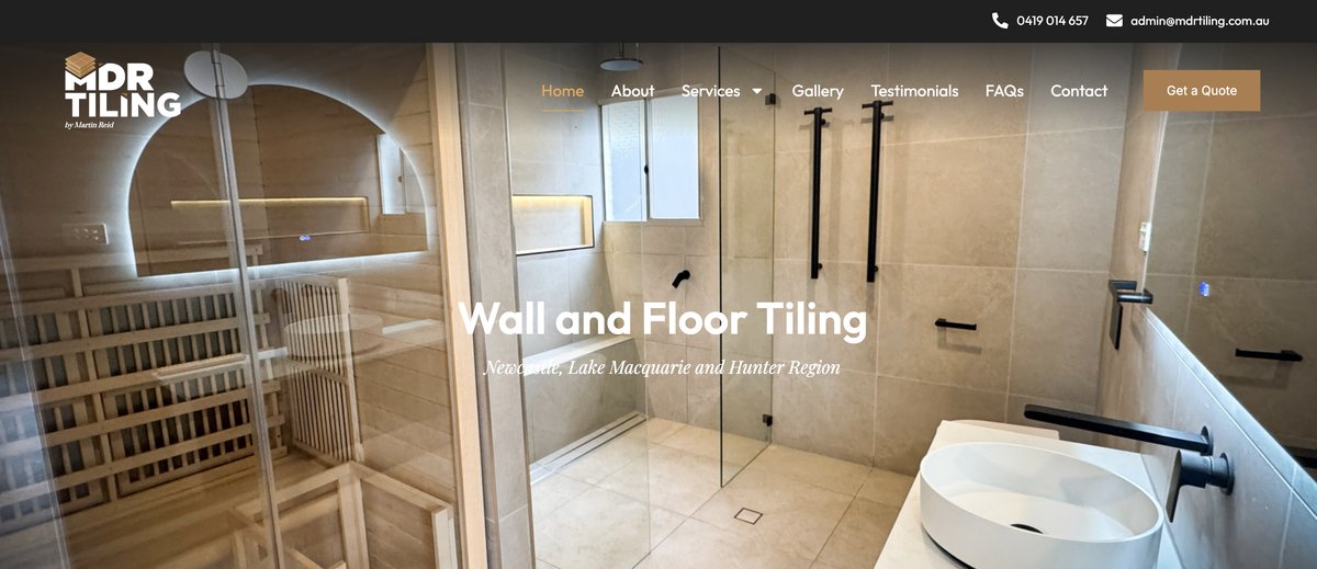 MDR Tiling homepage — a bathroom with tiled walls, glass shower screen, and header nav reading Wall and Floor Tiling Newcastle Lake Macquarie and Hunter Region